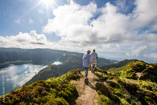 Miradouro da Lagoa Do Fogo, two elderly people trekking in a scenic landscape. Nordic wlaking in Azores, trekking in Lagoa do Fogo, isla sao miguel, travel tourism inclusion.  green mountains