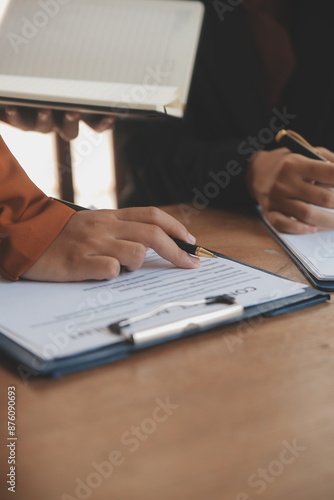 Wallpaper Mural Lawyer, legal advisor, businessman brainstorming information on agreement details Business contracts in legal processing books for accuracy in contract documents. joint financial investment. Torontodigital.ca