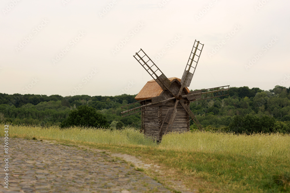 Fototapeta premium Old wooden windmill in the field