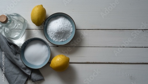 Baking soda, vinegar and lemons on white wooden table, flat lay 