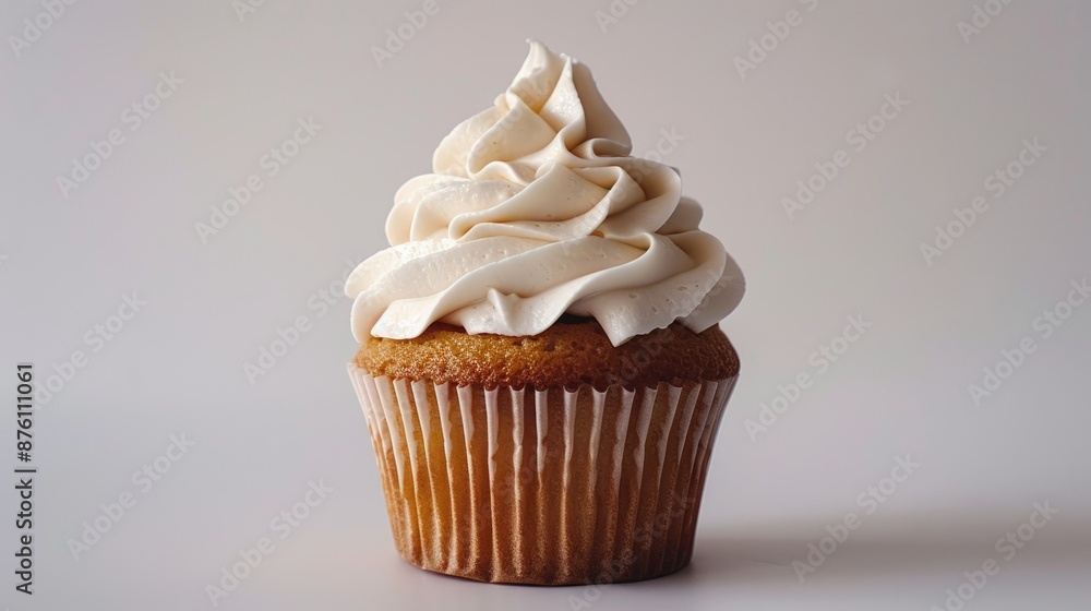Delicious vanilla cupcake with whipped cream frosting on white
