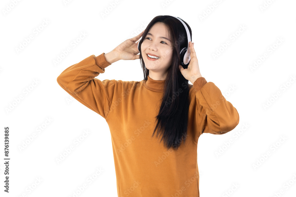 A young Asian woman wearing wireless headphones is happily listening to her favorite music isolated on white background with clipping path. A young Asian woman wearing wireless headphones is happily listening to her favorite music isolated on white background with clipping path.