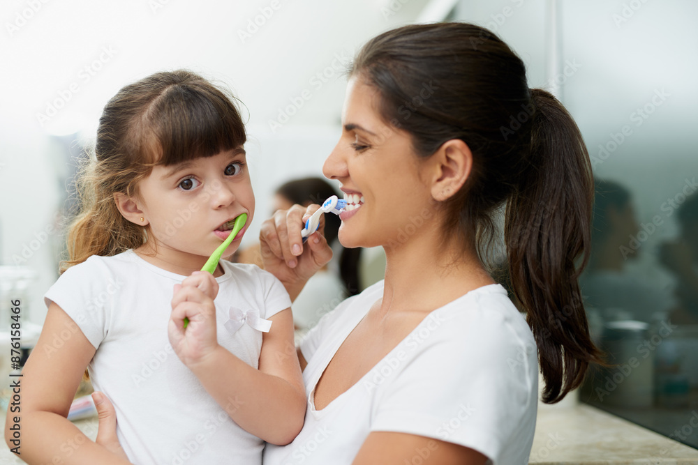 Mother, child and brushing teeth for dental hygiene, mouth health and wellness learning with smile. Home, bathroom and young girl with toothbrush, toothpaste to clean and morning with love and care Mother, child and brushing teeth for dental hygiene, mouth health and wellness learning with smile. Home, bathroom and young girl with toothbrush, toothpaste to clean and morning with love and care
