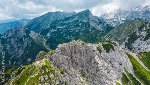 An awe-inspiring aerial view of the Slovenian Alps, featuring the majestic peaks of Viševnik, Jezerca, and Veliki Draški vrh. These stunning mountains offer breathtaking hiking trails photo