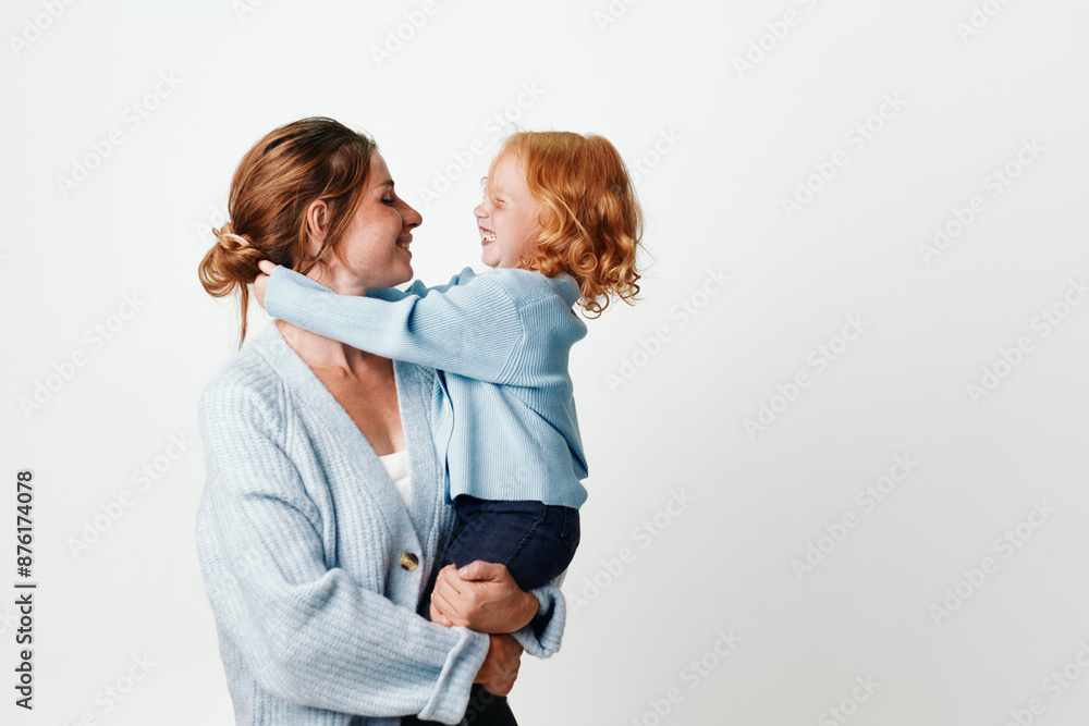 Mother and daughter embracing in front of white background, love and careful bonding concept Mother and daughter embracing in front of white background, love and careful bonding concept