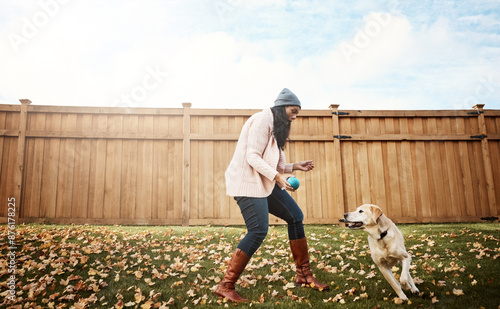 Dog, woman and playing in garden, park and retrieving with companion, hunting or loyalty. Labrador, happy and friendly puppy in backyard for exercise in autumn as family pet or emotion support animal