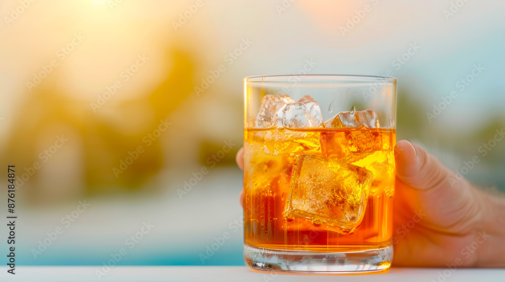 A man's hand reaches out for an Aperol Spritz cocktail on the bar counter by the pool, cafe menu advertising concept A man's hand reaches out for an Aperol Spritz cocktail on the bar counter by the pool, cafe menu advertising concept