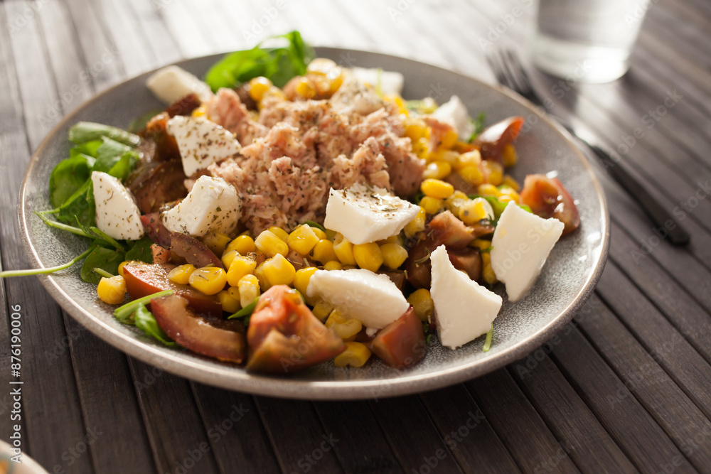 Plate of salad with tuna, corn, tomatoes and arugula Plate of salad with tuna, corn, tomatoes and arugula