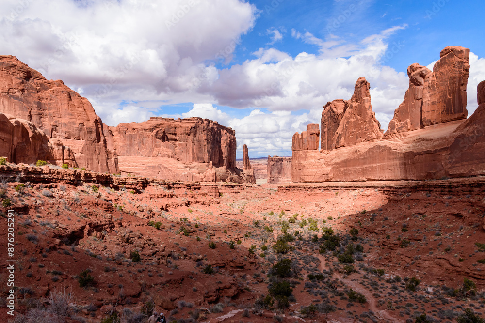 Breathtaking view of the Park Avenue area in Arches National Park, Utah, USA. Majestic red rock formations under a bright, partly cloudy sky. Perfect for travel, nature, and adventure themes. Breathtaking view of the Park Avenue area in Arches National Park, Utah, USA. Majestic red rock formations under a bright, partly cloudy sky. Perfect for travel, nature, and adventure themes.