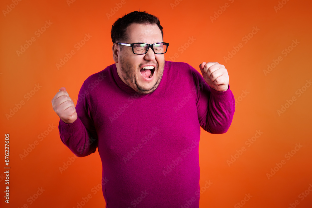 The funny man was scared and surprised. Orange background. The funny man was scared and surprised. Orange background.