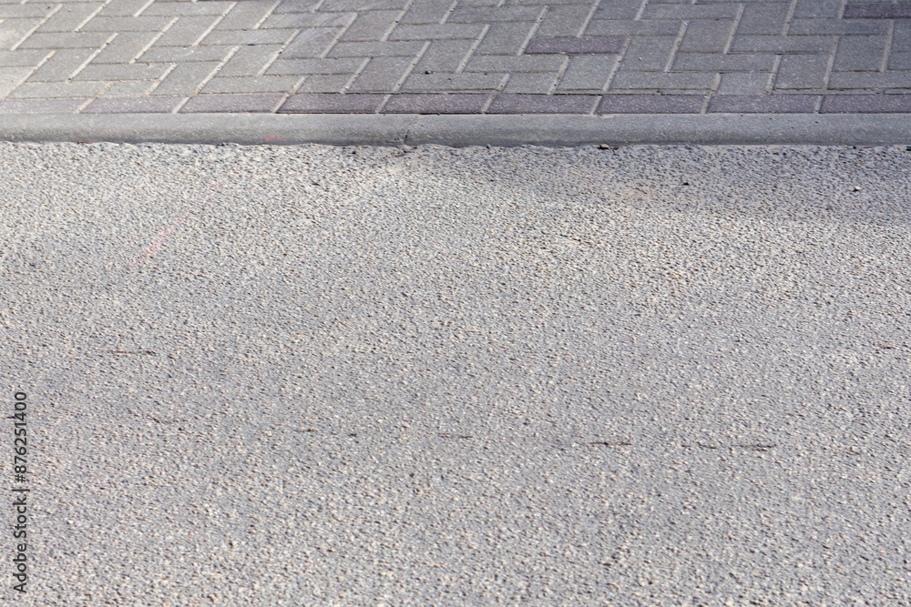 Fototapeta premium blocks on the pavement with an asphalt street surface