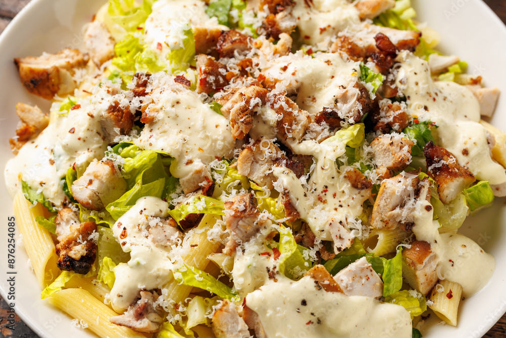 Chicken Caesar Pasta Salad with sauce in white plate. Healthy food. Chicken Caesar Pasta Salad with sauce in white plate. Healthy food.