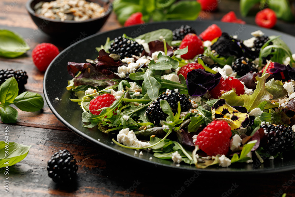 Summer berries salad with edible flowers, feta cheese and seeds Summer berries salad with edible flowers, feta cheese and seeds