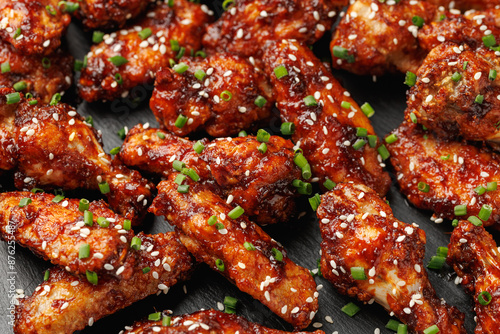 Spicy korean chicken wings with sesame seeds and chives