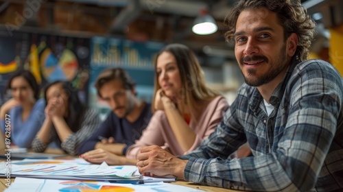 Business Manager and Team Analyzing Charts and Graphs Together in a Meeting