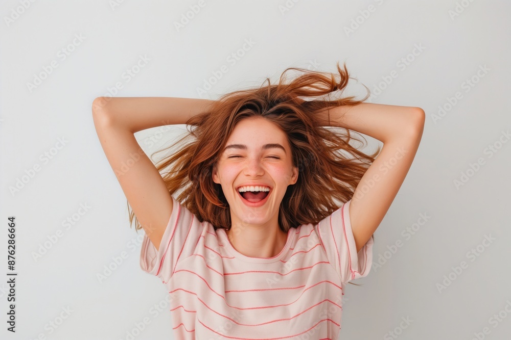 Studio portrait of a brunette model with long hair, smiling confidently Studio portrait of a brunette model with long hair, smiling confidently