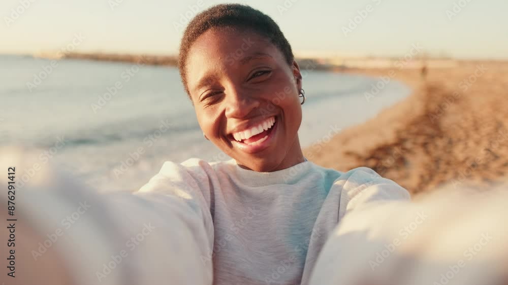 Portrait of a happy girl smiling and taking a selfie while walking by the sea Portrait of a happy girl smiling and taking a selfie while walking by the sea
