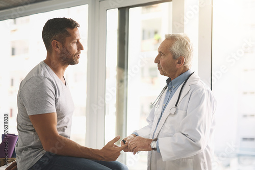 Clinic, doctor and man with diabetes test, advice and consultation for healthcare assessment. Discussion, patient and medical professional checking glucose, insulin or wellness for health insurance © peopleimages.com