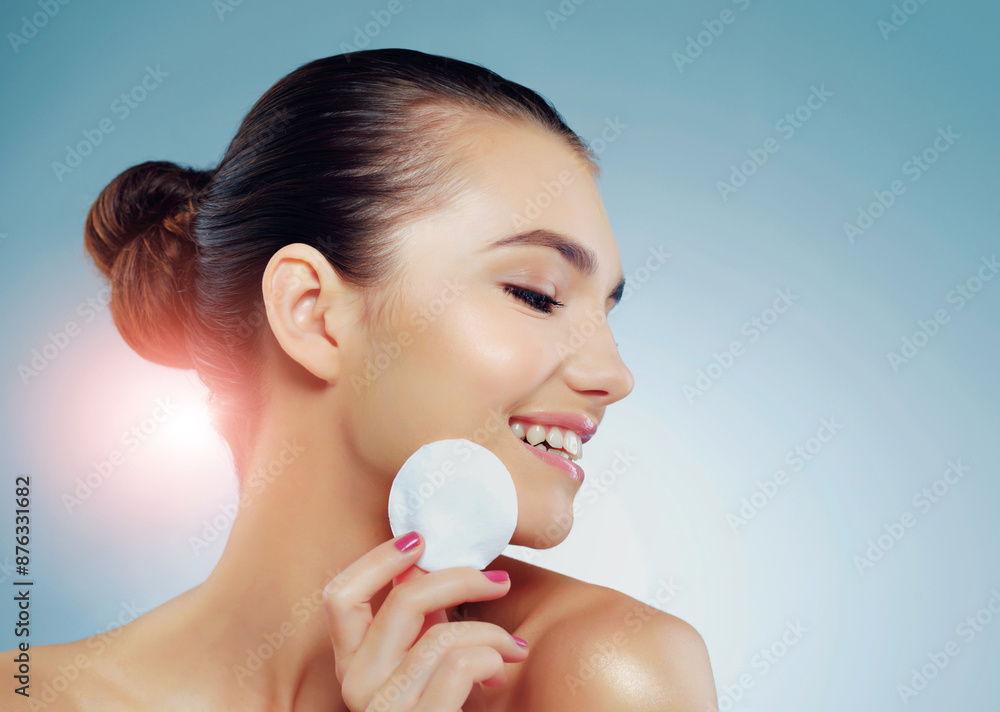 Profile, woman and cotton pad for skincare in studio with beauty, smile and dermatology. Model girl, happy and confidence for makeup removal, treatment and wellness for aesthetic by blue background Profile, woman and cotton pad for skincare in studio with beauty, smile and dermatology. Model girl, happy and confidence for makeup removal, treatment and wellness for aesthetic by blue background