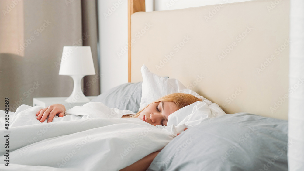 Lazy comfort. Free day. Carefree morning. Positive relaxed satisfied young girl sleeping enjoying resting recovering in cozy bed at home. Lazy comfort. Free day. Carefree morning. Positive relaxed satisfied young girl sleeping enjoying resting recovering in cozy bed at home.