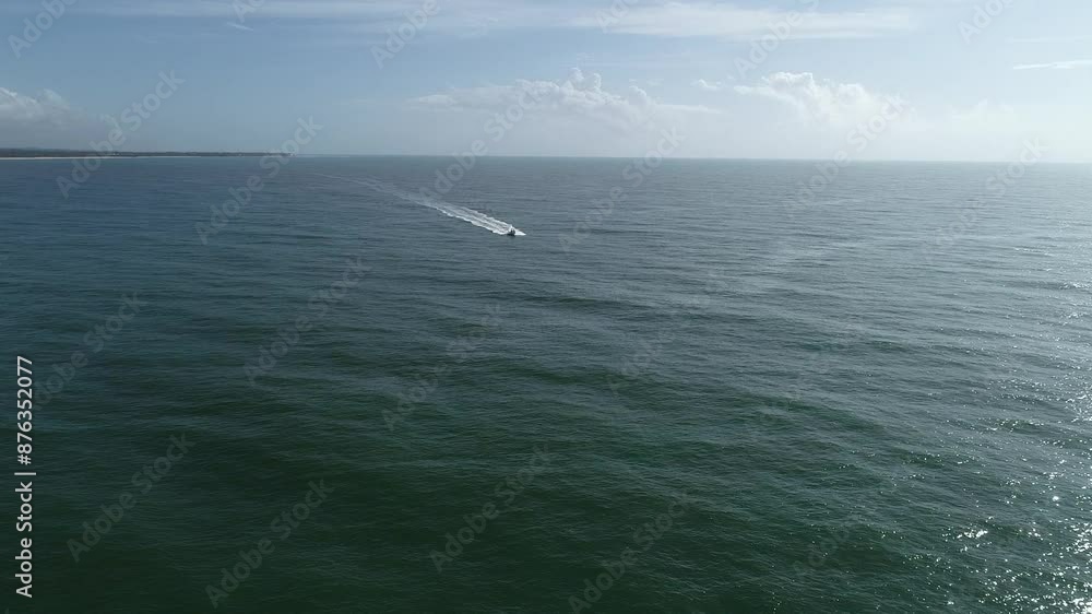 Speedboat in the sea approaching at speed leaving trails and movements in the water Speedboat in the sea approaching at speed leaving trails and movements in the water