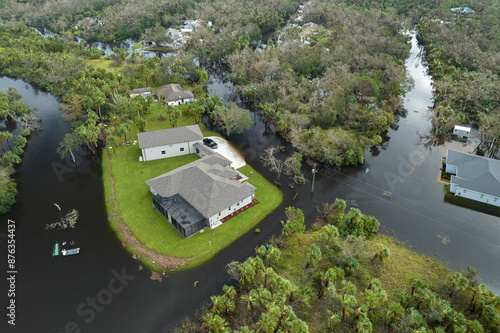 Surrounded by hurricane Ian rainfall flood waters homes in Florida residential area. Aftermath of natural disaster photo