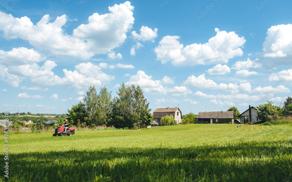 Man on lawn tractor mowing lawn on backyard. The red rider. The lawnmower tractor. High quality 4k footage Man on lawn tractor mowing lawn on backyard. The red rider. The lawnmower tractor. High quality 4k footage