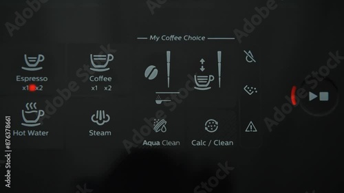 Hand pressing the touch button on a coffee machine. Coffee preparation