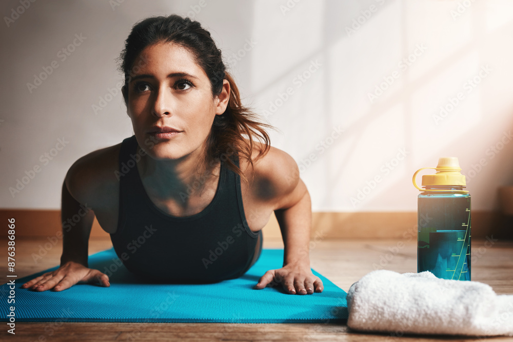Fototapeta premium Fitness, push up and balance with woman in home for power, strength training or workout on wood floor. Exercise, health and wellness with confident athlete on yoga mat for challenge or performance