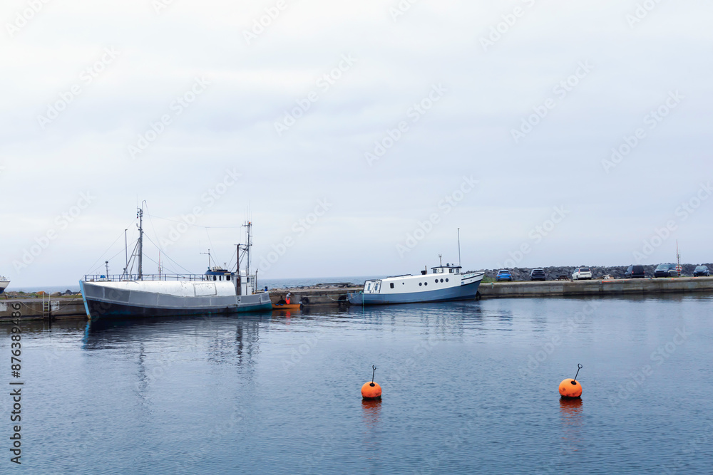 Fototapeta premium Sea pier with boats on a cloudy day