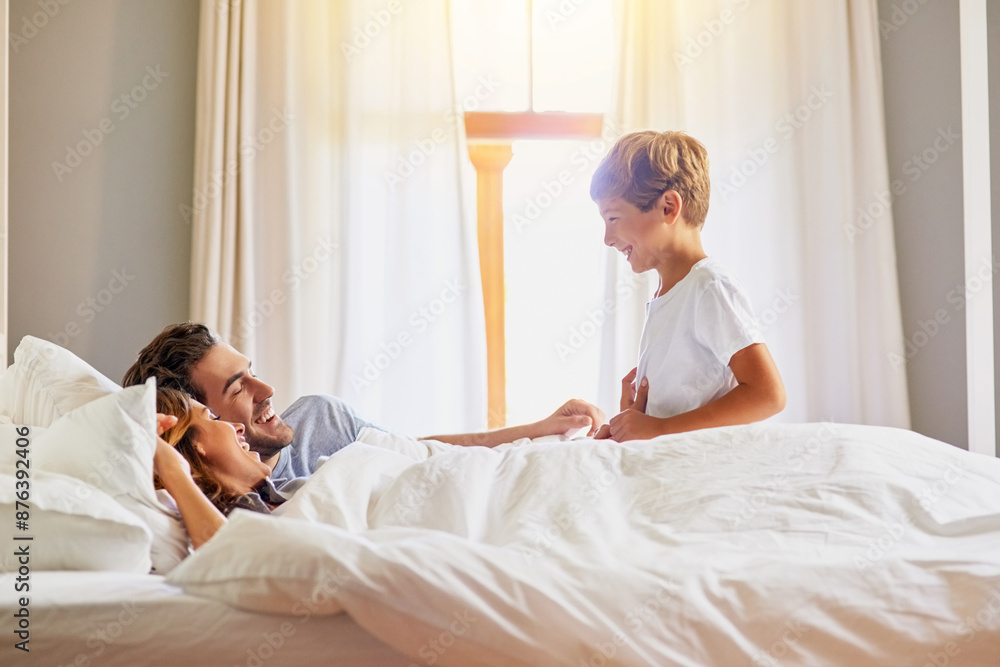 Fototapeta premium Happiness, family and kid on bed for play, excited and ready for weekend at home. Mom, dad and boy child and energy in morning for fun, bonding and game in bedroom with smile, support and love