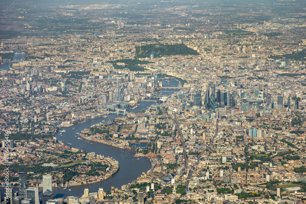 Fototapeta premium High aerial view of downtown city of London, with river Thames, the Shard, Tower bridge, HMS Belfast and may buildings, squares, offices. embankment, taken from airplane