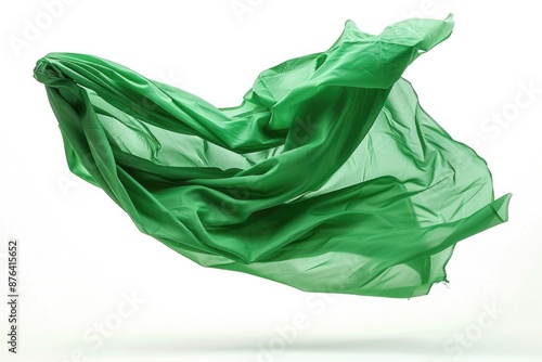 A green cloth floats through the air with a gentle motion