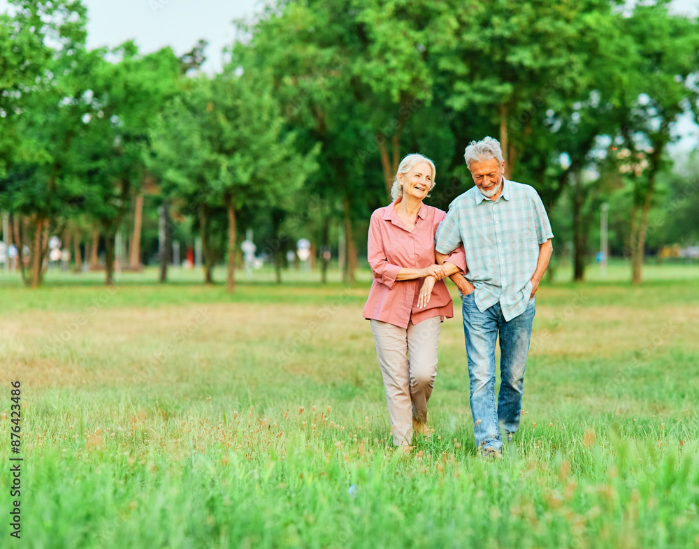 Fototapeta premium woman man senior couple happy retirement together elderly active love vitality bonding park outdoor walking holding hands leisure park fun smiling old