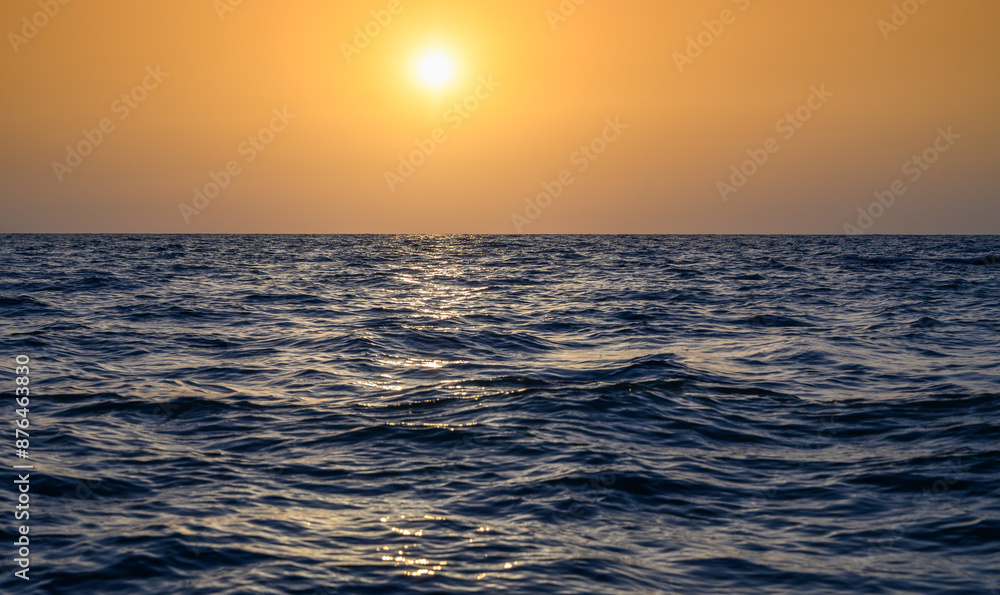 Warm waves of the Mediterranean Sea and sandy beach at sunset Warm waves of the Mediterranean Sea and sandy beach at sunset