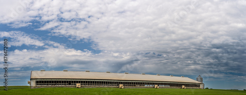 Hog animal confinement barn in a rural setting with cloudy skies  photo