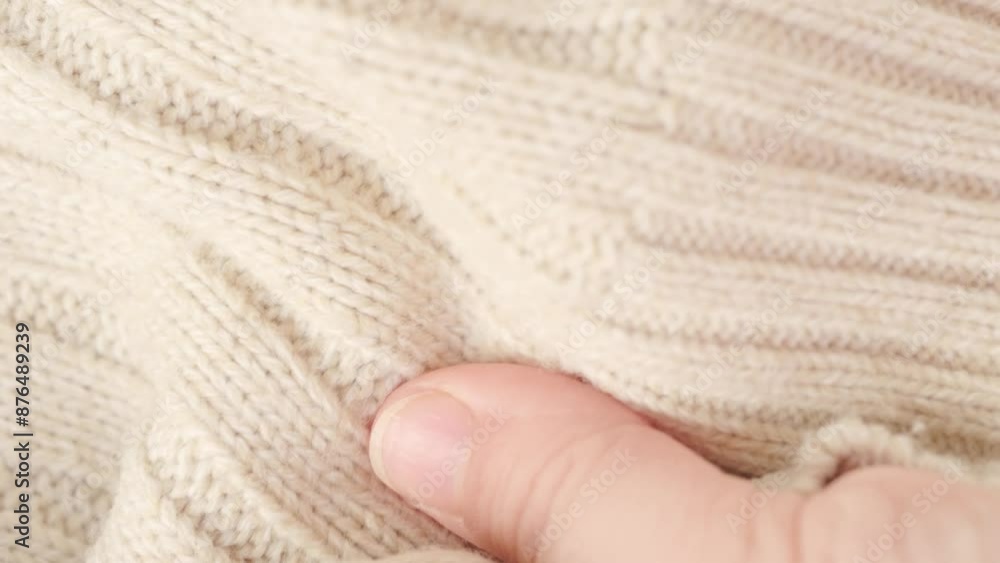 female Hand touching knitted wool cloth or warm fluffy sweater, Handcraft knitting woolen fabric surface, tactile properties, fabric testing female Hand touching knitted wool cloth or warm fluffy sweater, Handcraft knitting woolen fabric surface, tactile properties, fabric testing