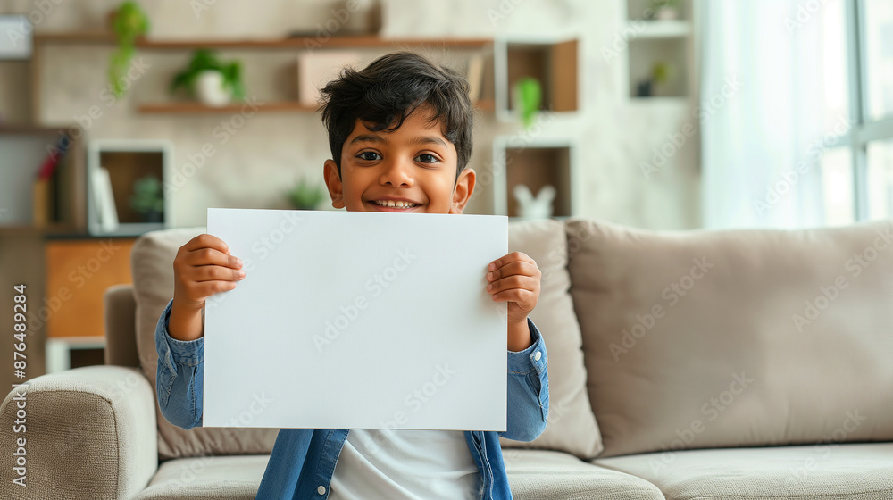 Indian kid holding a placard in living room Indian kid holding a placard in living room