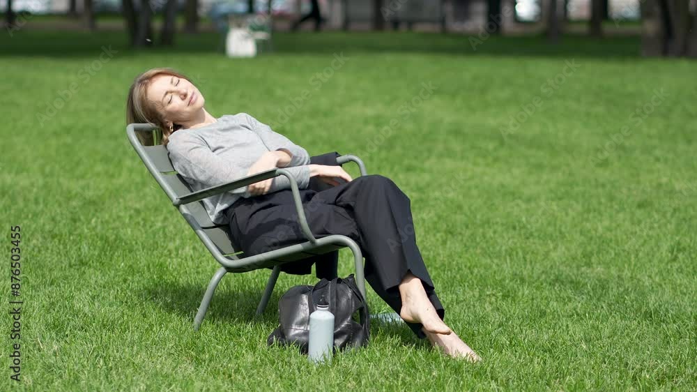 Calm woman sleeping, napping outdoors outside with satisfied smile on face. Glad pleased woman resting, taking break, pause from work, tasks, spending peaceful quiet time in nature, daydreaming. Calm woman sleeping, napping outdoors outside with satisfied smile on face. Glad pleased woman resting, taking break, pause from work, tasks, spending peaceful quiet time in nature, daydreaming.