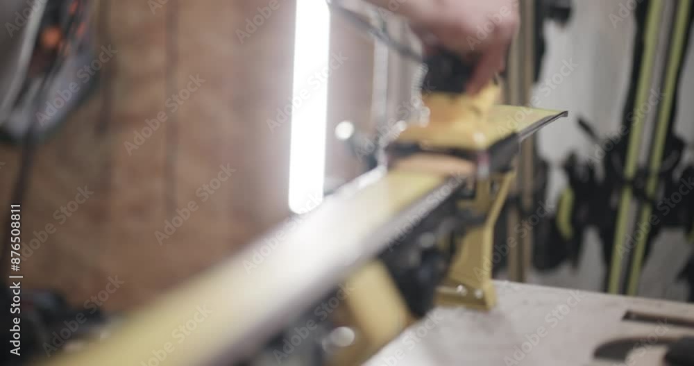 Man servicing skis. Ironing hot wax. Abstract close up video recorded with cinema camera. Man servicing skis. Ironing hot wax. Abstract close up video recorded with cinema camera.