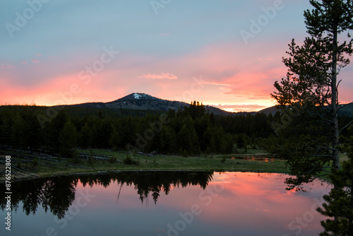 Sunset over a pond and pine trees, in Yellowstone National Park,