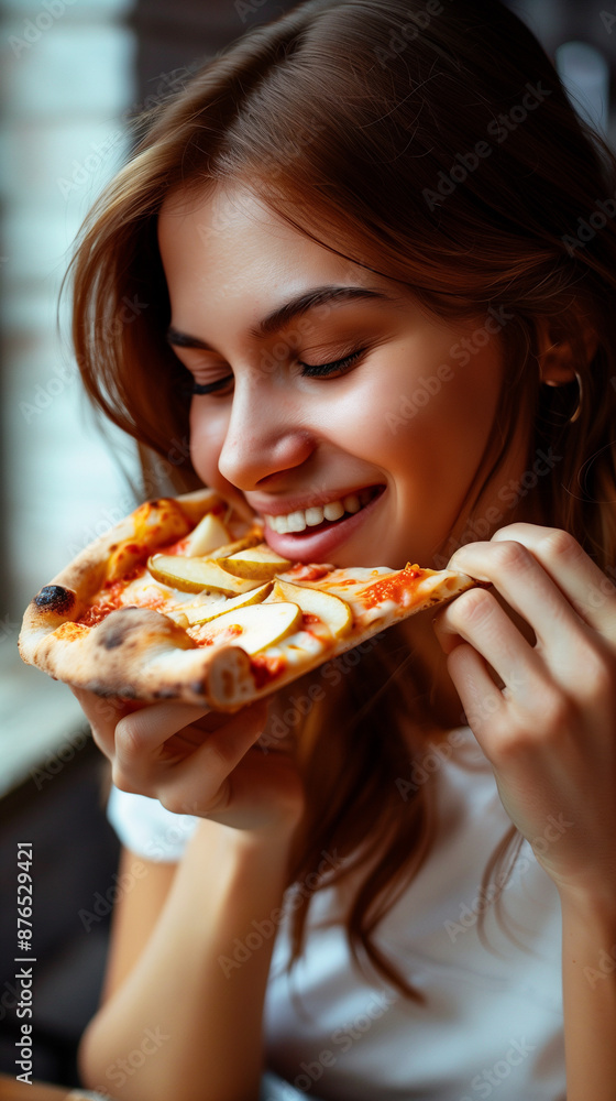 Happy woman eating pizza, smiling, facing camera, pizza in hand, happy woman looking down and eating pizza slice Happy woman eating pizza, smiling, facing camera, pizza in hand, happy woman looking down and eating pizza slice