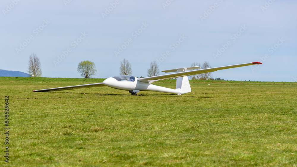 White glider on the grass airfield