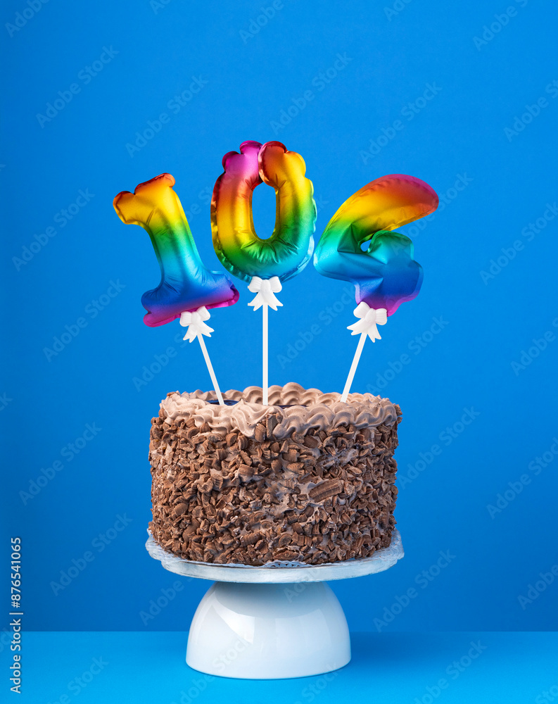 Air balloon number 104 - Birthday cake on blue background Air balloon number 104 - Birthday cake on blue background
