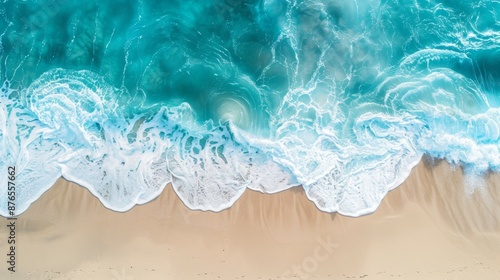 An aerial photograph captures waves rhythmically crashing and retreating on a sandy beach, showcasing the serene interaction between ocean and shore in nature's harmony.