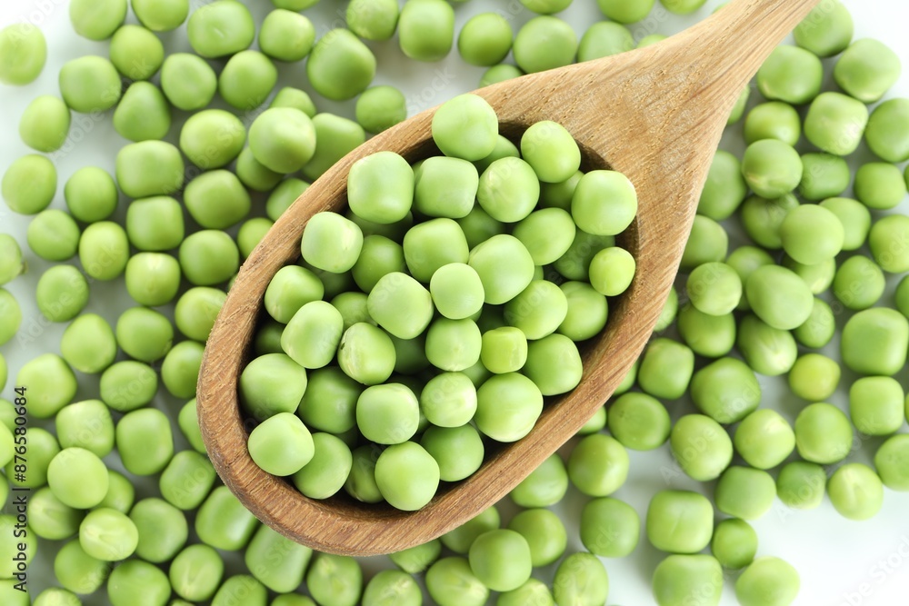 Fresh green peas and spoon on white background, top view Fresh green peas and spoon on white background, top view