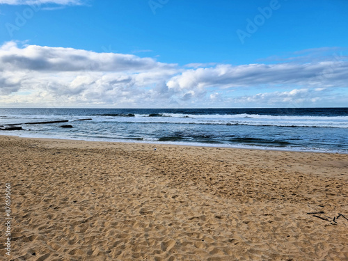 Deserted Bar Beach Newcastle New South Wales. On a Cold Winter's Day. Sandy Beach With Blue Sky Clouds and Surf photo