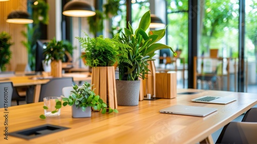 Modern open office workspace with abundant greenery, wooden desks, and natural light creating a productive and eco-friendly environment.