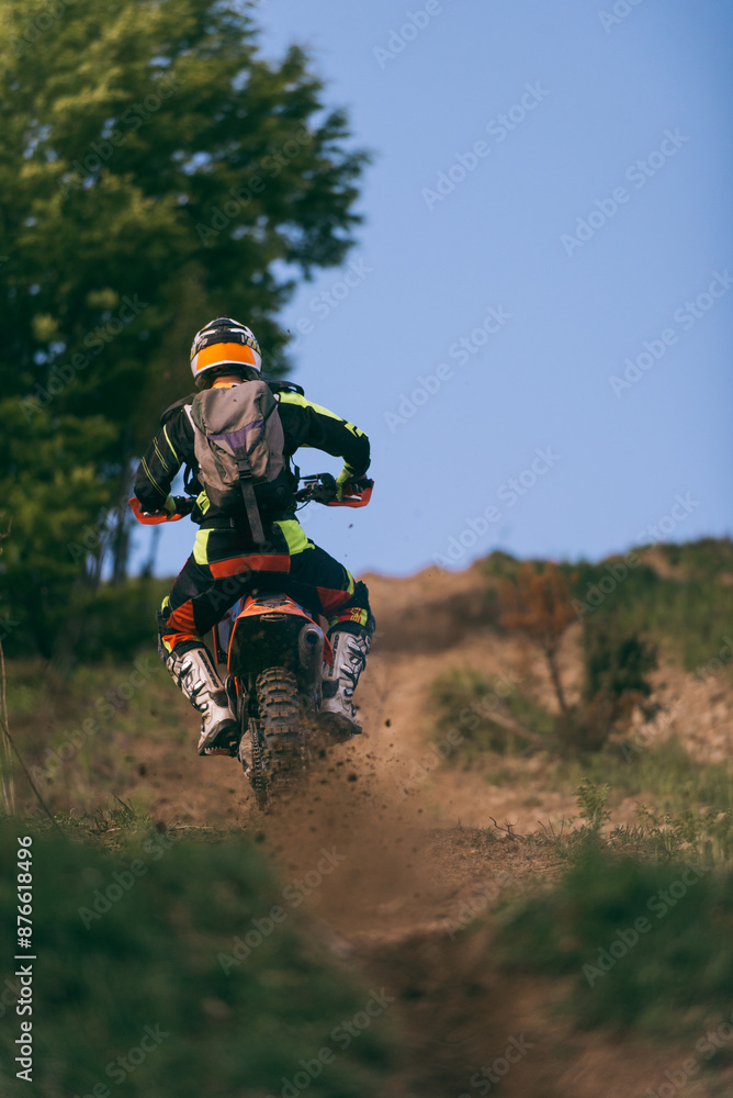 Professional enduro bike rider on action, dirt ride on the muddy road. Motocross sport. Professional enduro bike rider on action, dirt ride on the muddy road. Motocross sport.