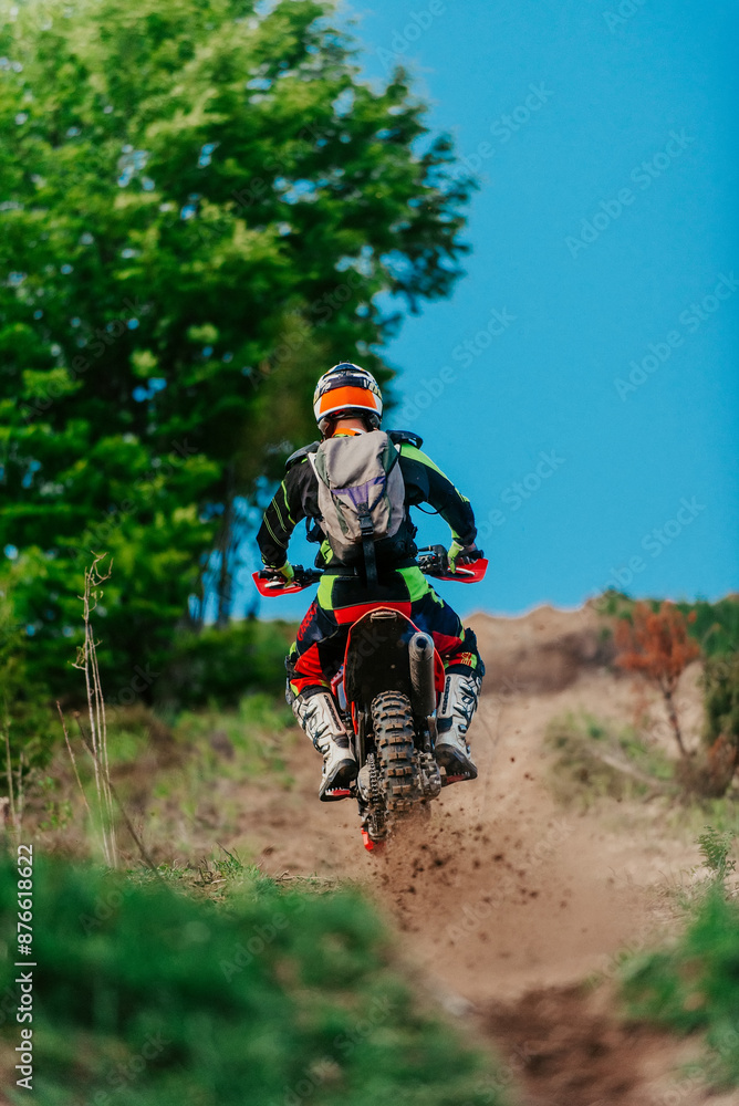 Professional enduro bike rider on action, dirt ride on the muddy road. Motocross sport. Professional enduro bike rider on action, dirt ride on the muddy road. Motocross sport.